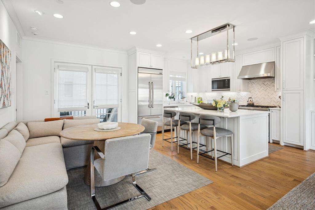 3420 Rosedale Avenue, Unit 2 University Park, TX 75205 - Photo 11 of 28 a dining room with stainless steel appliances kitchen island granite countertop a sink and chairs