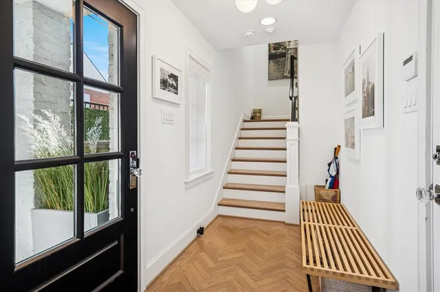 a view of entryway and hall with wooden floor