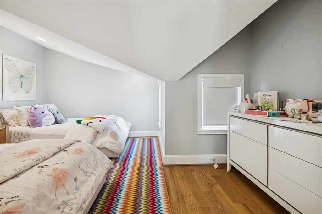 3420 Rosedale Avenue, Unit 2 University Park, TX 75205 - Photo 23 of 28 a bedroom with a bed and a book shelf