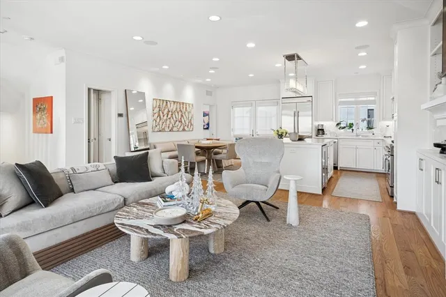 a living room with furniture and kitchen view