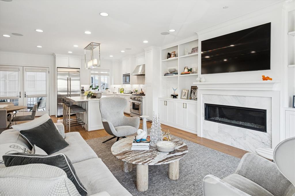3420 Rosedale Avenue, Unit 2 University Park, TX 75205 - Photo 8 of 28 a living room with furniture a flat screen tv and kitchen view