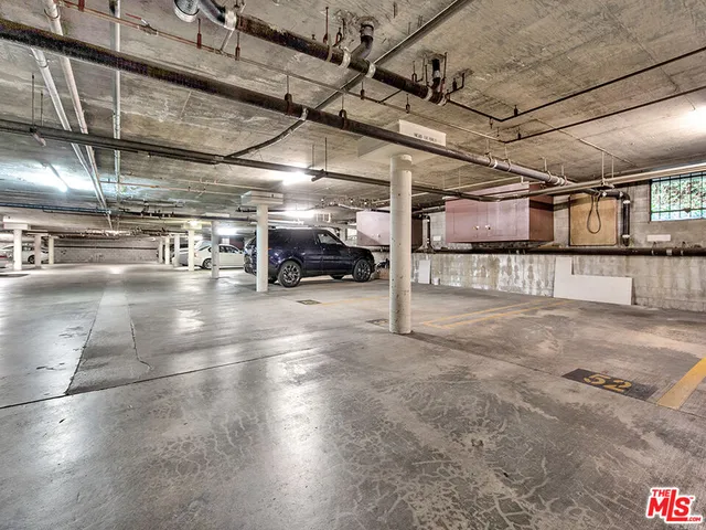 a view of parking garage with lots of traffic signal