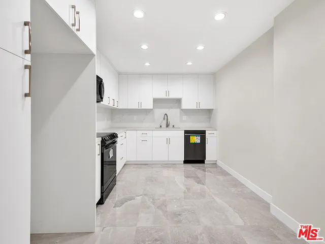 a view of kitchen with microwave and cabinets