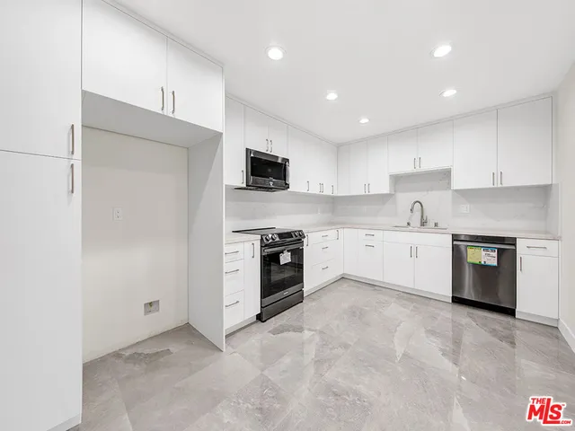 a kitchen with a refrigerator stove and a sink