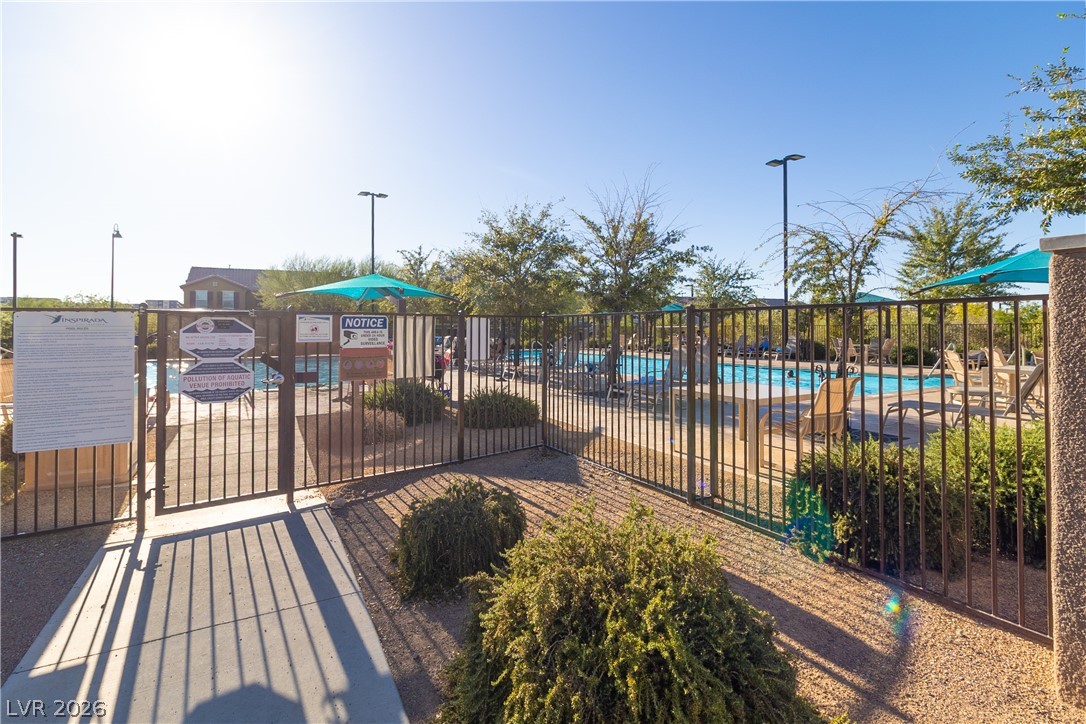 2182 Trivero Street Henderson, NV 89044 - Photo 47 of 50 A secure gated entry leads directly to the community swimming pool and patio area.
