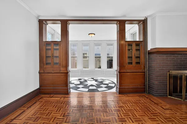 a view of a balcony with wooden floor and furniture