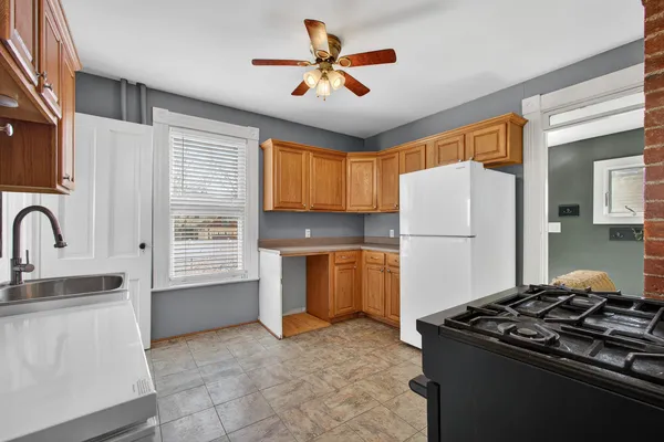 a kitchen with refrigerator and window