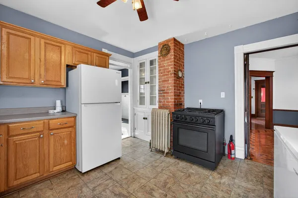 a kitchen with a stove a sink and a refrigerator