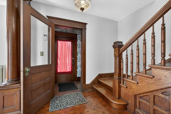 a view of entryway with wooden floor and stairs