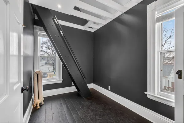 a view of an empty room and wooden floor
