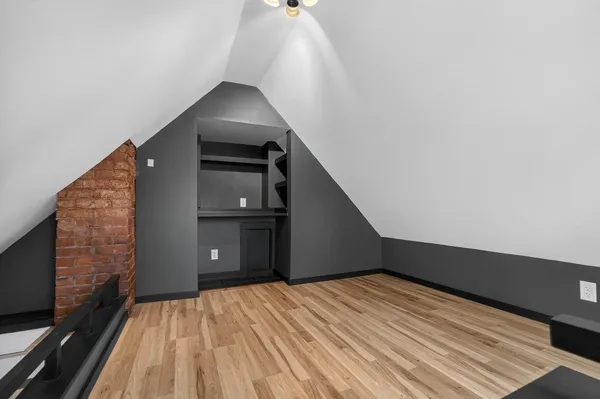 a view of a livingroom with wooden floor and stairs