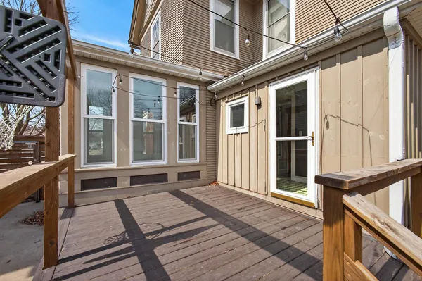 a view of a house with backyard and wooden fence