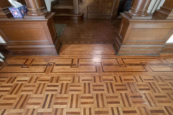 a view of empty room with wooden floor and fireplace