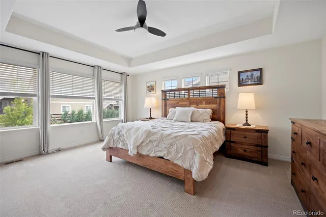 a spacious bedroom with a bed and wooden floor