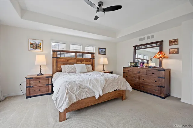 a bedroom with a bed dresser and window
