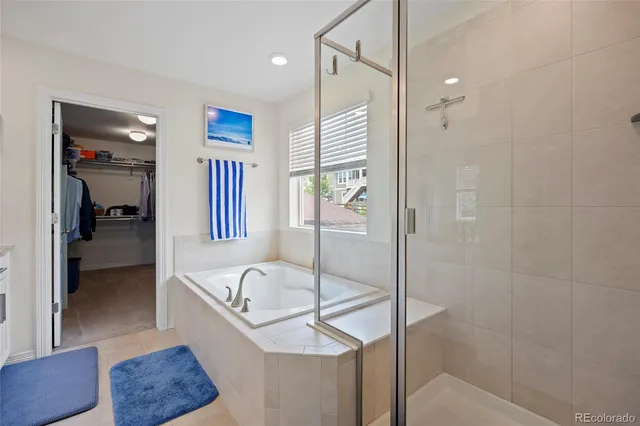 a bathroom with a tub and shower