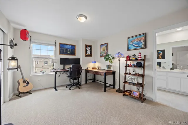 a living room with furniture and a gym machine