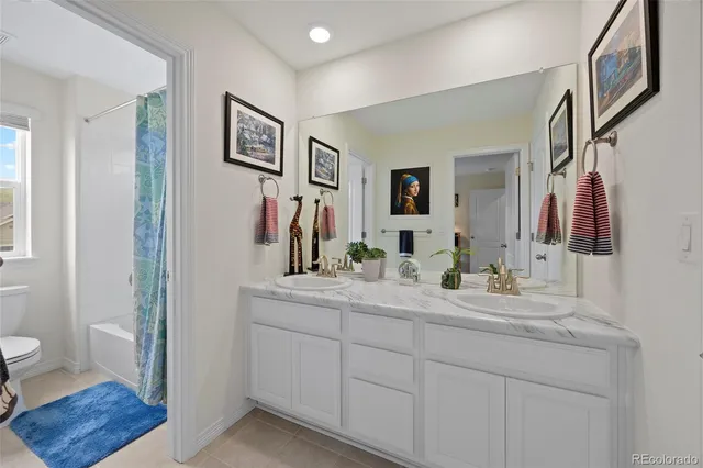 a en suite bathroom with a toilet sink and mirror