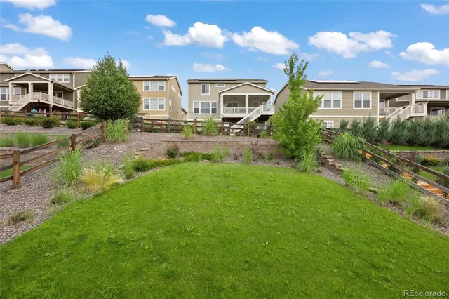 a front view of a house with a yard and trees