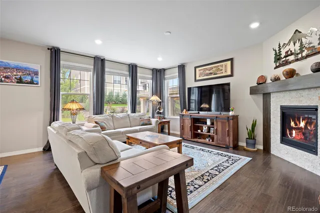 a living room with fireplace furniture and a flat screen tv