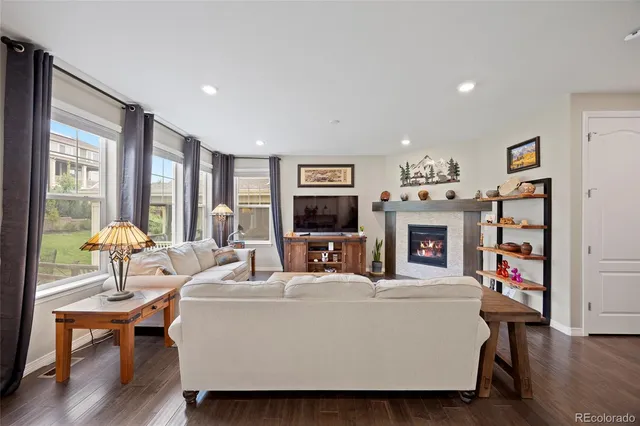 a living room with furniture a fireplace and a flat screen tv