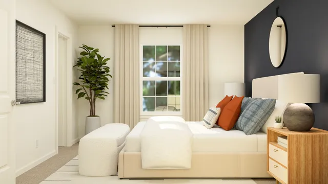 a bedroom with a bed and a potted plant