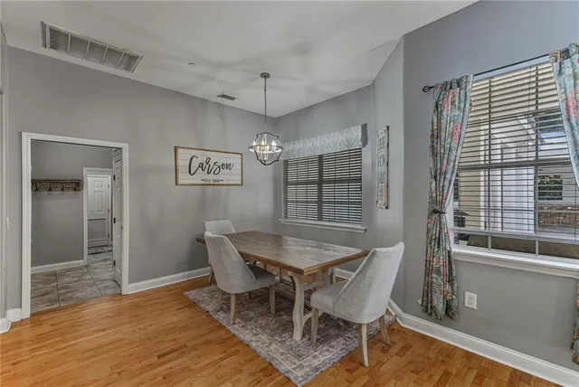 a view of a dining room with furniture and a chandelier