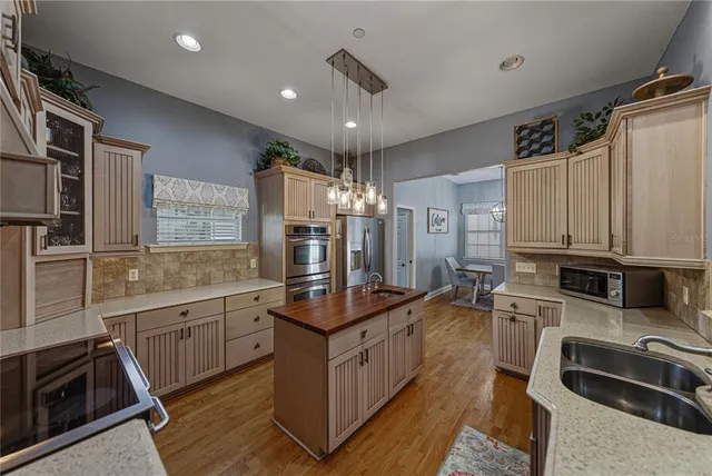 a spacious bathroom with a double vanity sink mirror and bathtub