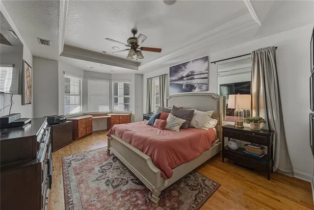 a spacious bedroom with a bed and a walk in closet