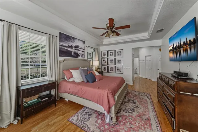 a spacious bedroom with a bed and a chandelier