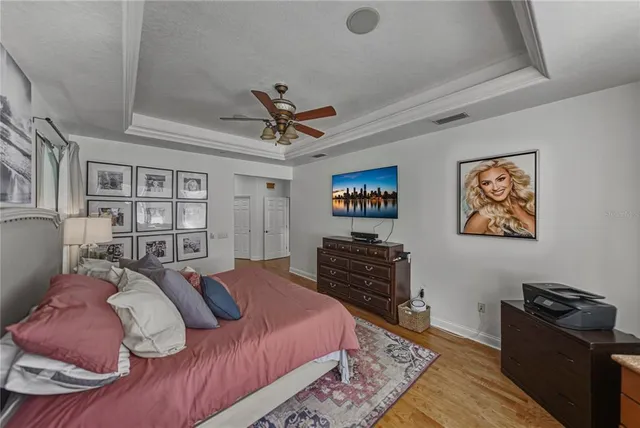 a bedroom with a bed and a chandelier