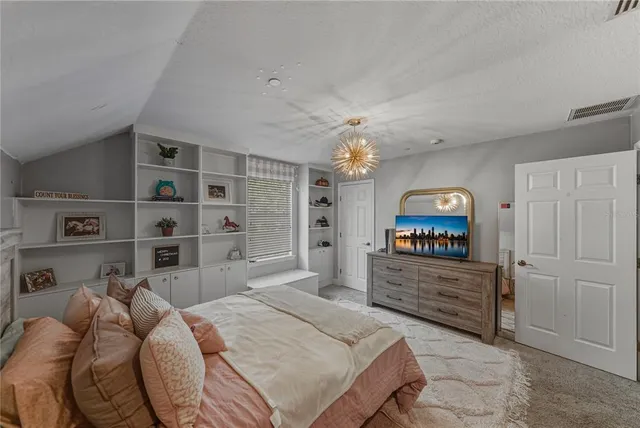 a view of living room kitchen with furniture and large windows