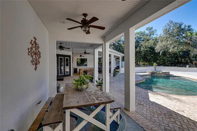 a view of a patio with table and chairs floor to ceiling window with wooden floor