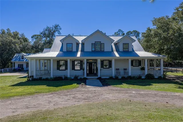 a view of a dining room with furniture a chandelier and wooden floor
