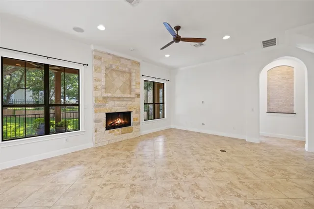a living room with furniture and large windows