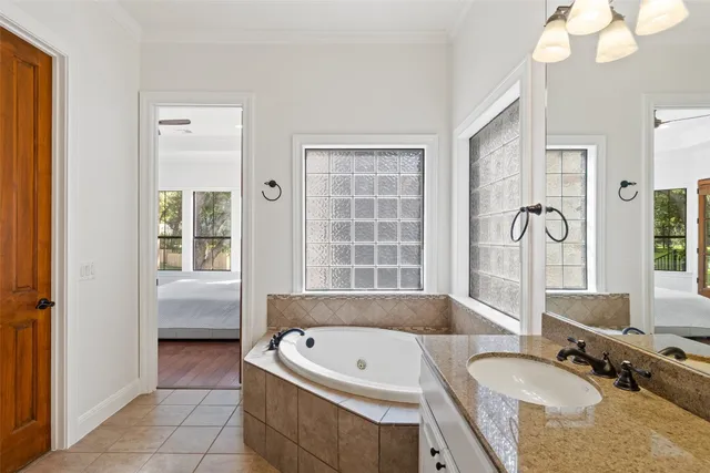 a view of an empty room with a ceiling fan and a window