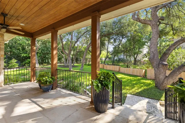 a backyard of a house with barbeque oven table and chairs