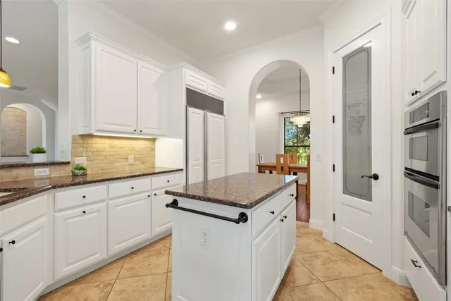 a kitchen with granite countertop a sink and cabinets