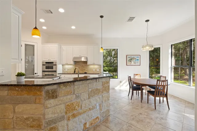 a view of an empty room with a fireplace and a window