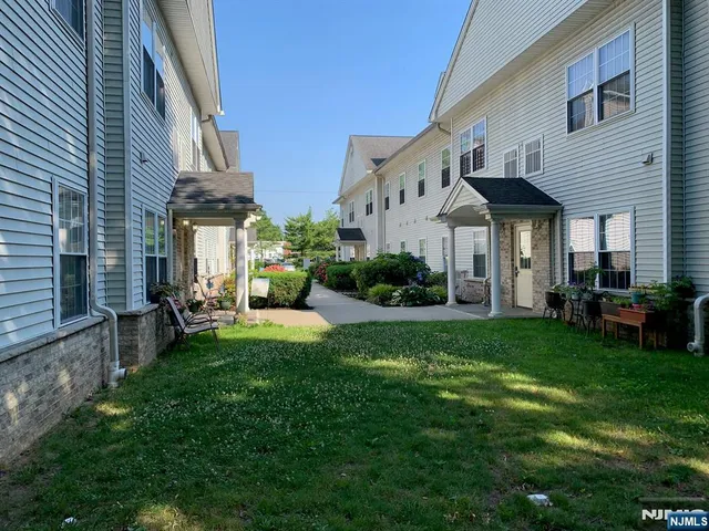 a view of a house with a yard porch and sitting area