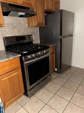a kitchen with a stove and a refrigerator