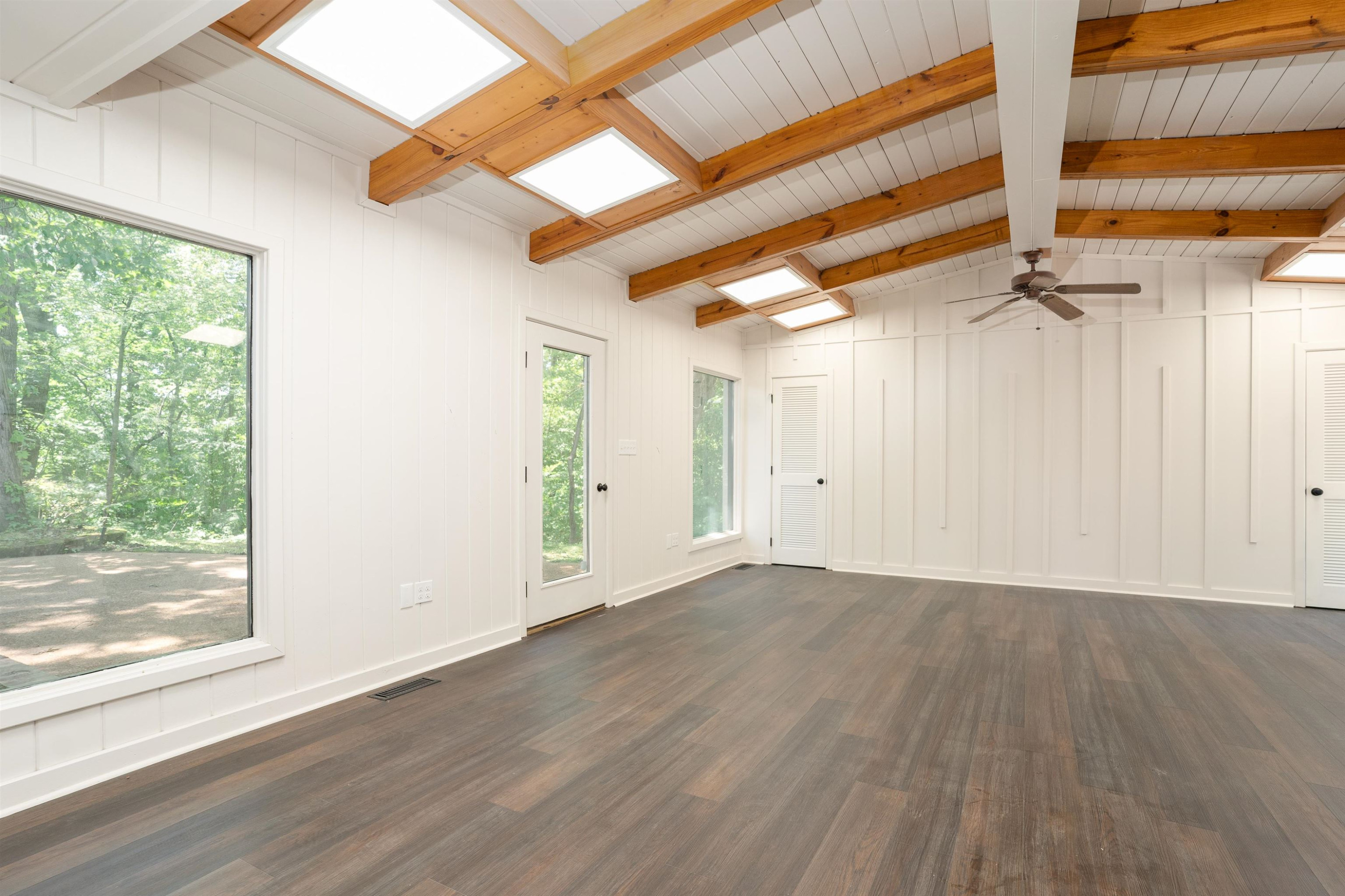 412 Wiley Parker Road Jackson, TN 38305 - Photo 14 of 28 a view of an empty room with wooden floor and a window