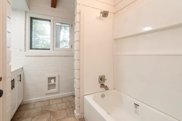 a bathroom with a bathtub and a shower