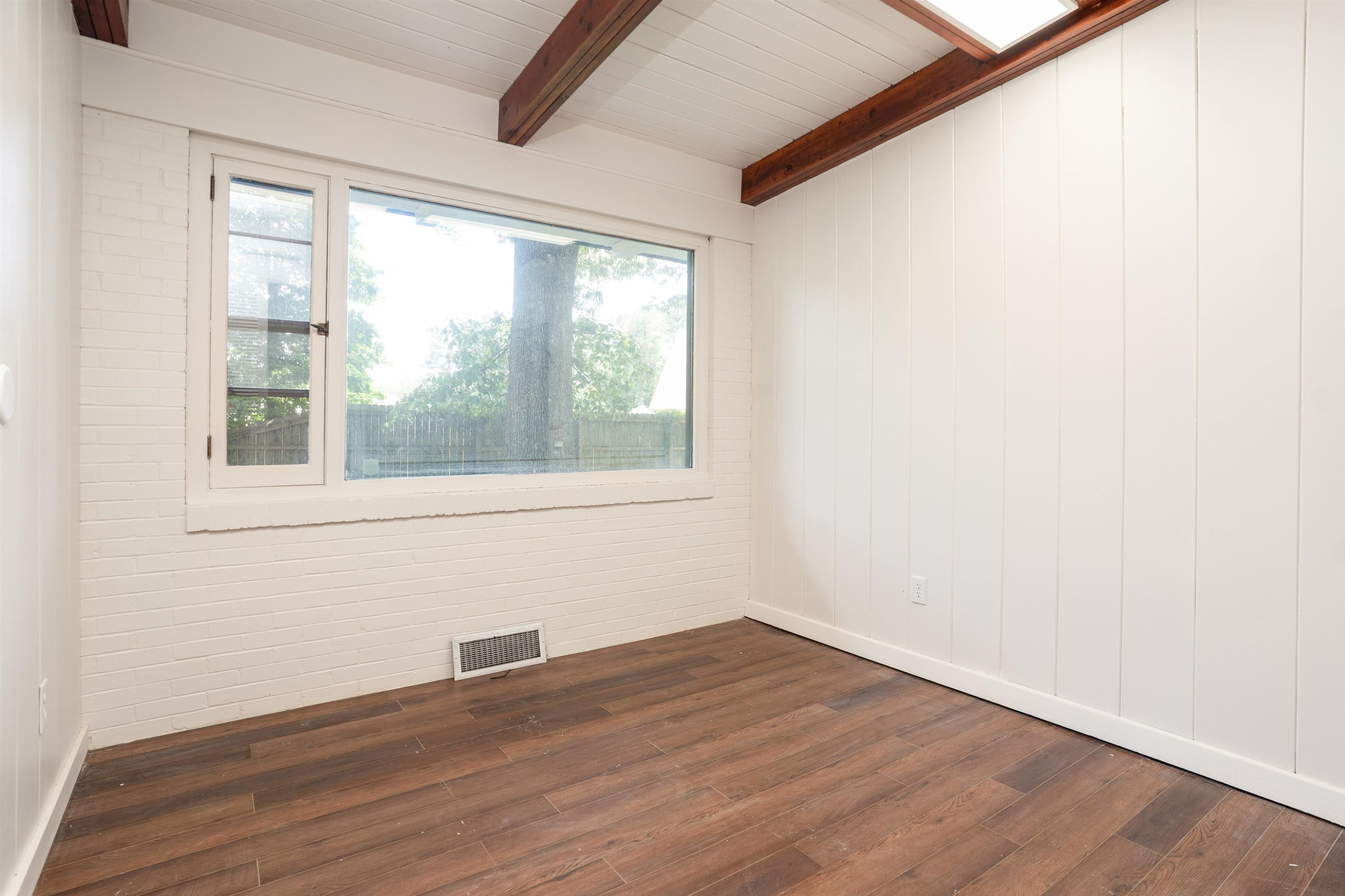 412 Wiley Parker Road Jackson, TN 38305 - Photo 20 of 28 a view of empty room with wooden floor and fan