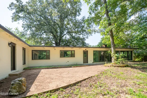 a house with trees in the background