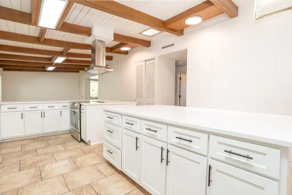 a kitchen with white cabinets and white appliances
