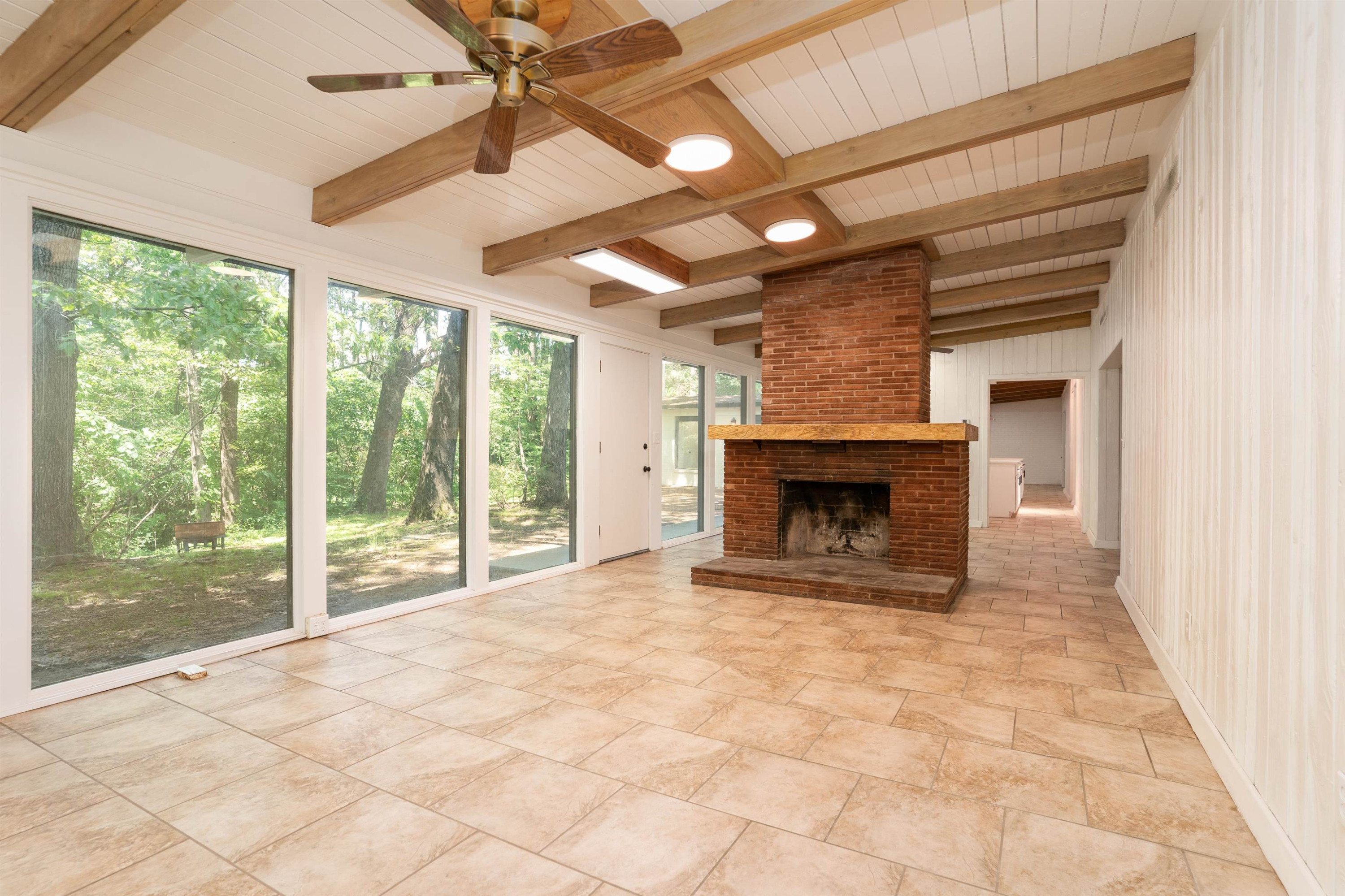 412 Wiley Parker Road Jackson, TN 38305 - Photo 5 of 28 a view of empty room with fireplace and fan