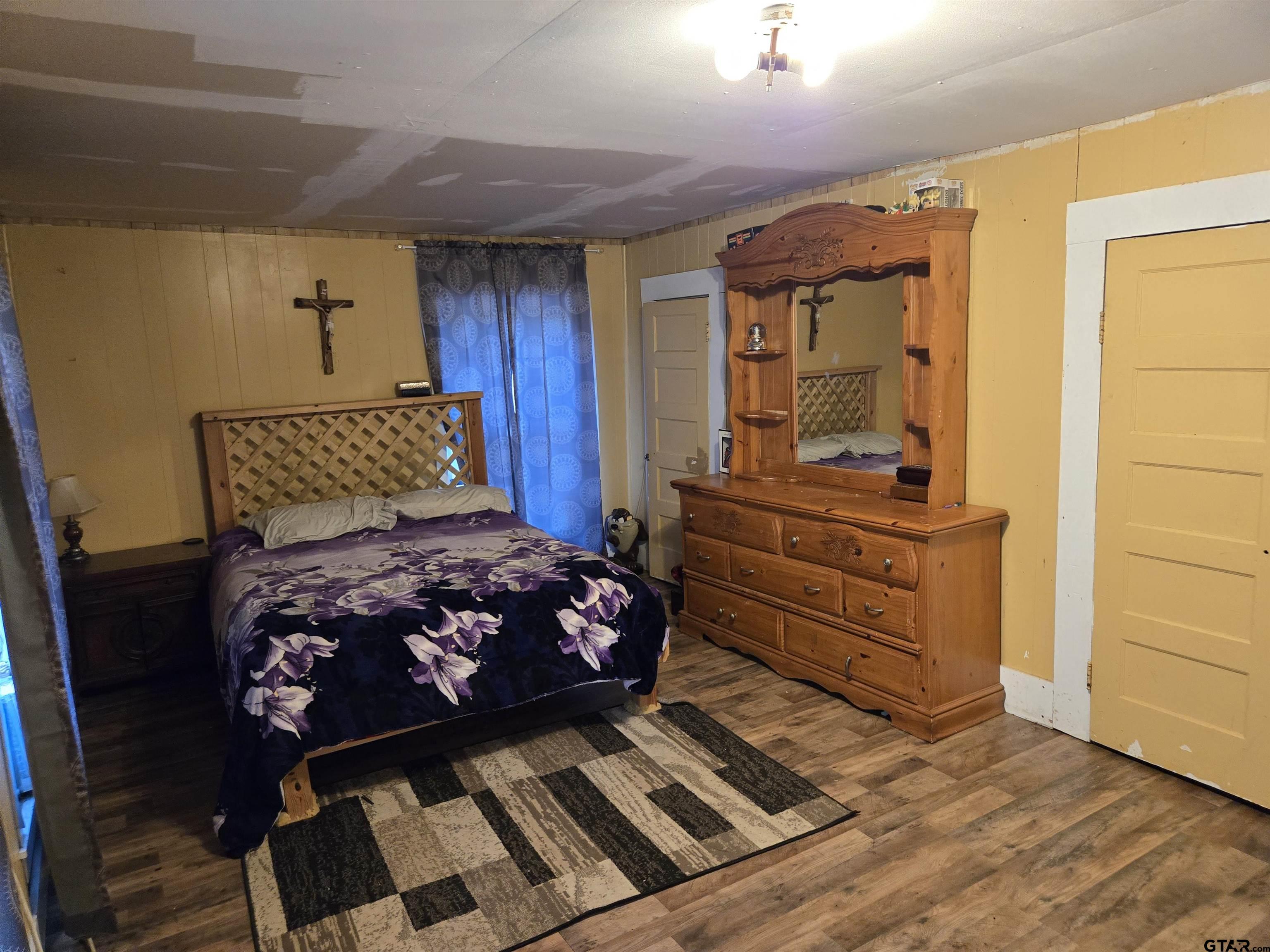 151 Joplin Rusk, TX 75785 - Photo 3 of 17 a bedroom with a bed and wooden floor