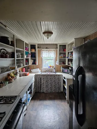 a kitchen with refrigerator and window