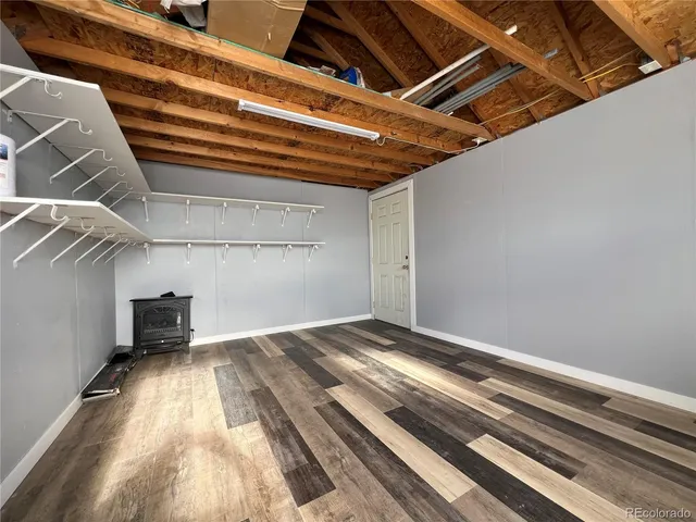 a view of a room with wooden floor